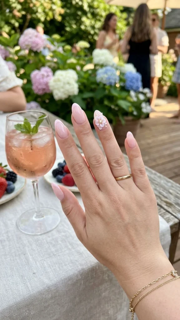Minimal pink French manicure with one elegant 3D flower.