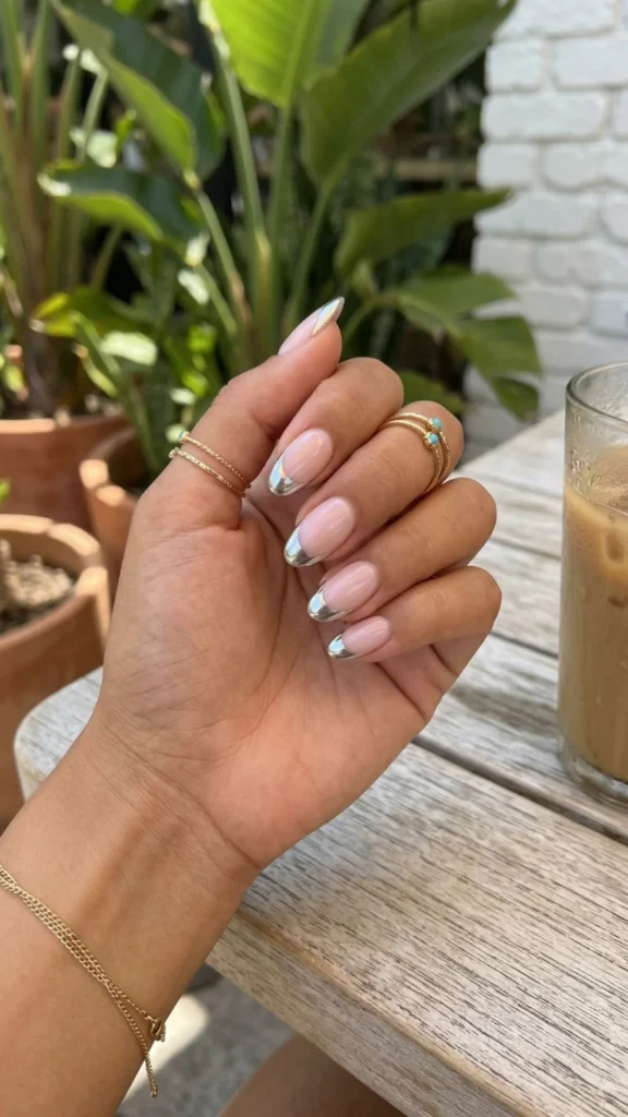 Classic French tip nails upgraded with elegant chrome metallic accents.