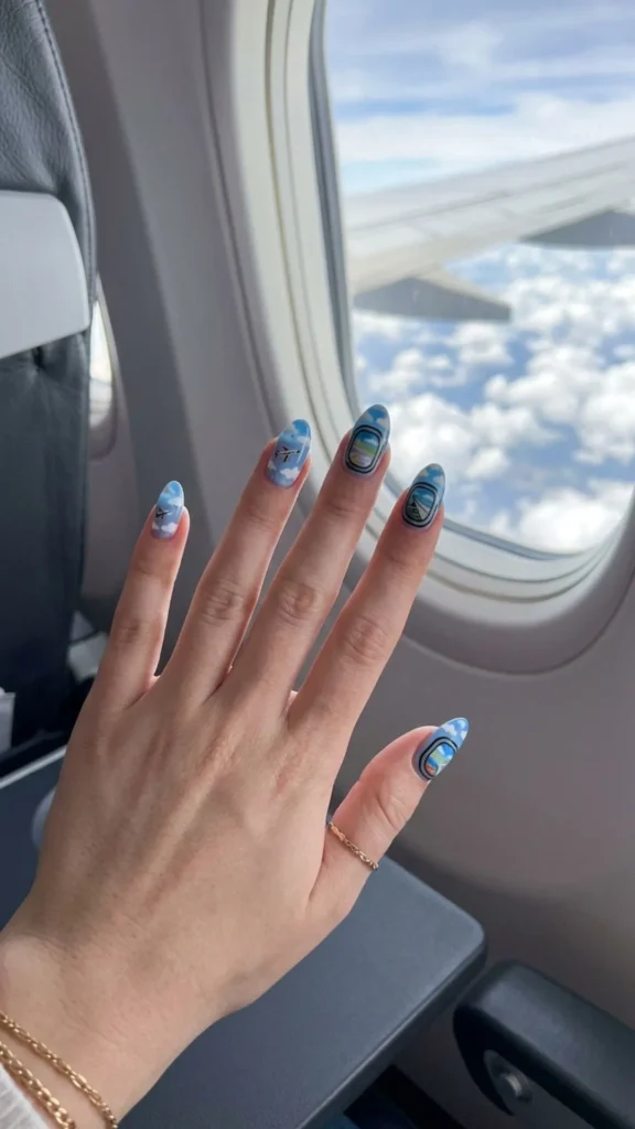Adorable airplane window nails showcasing dreamy clouds, blue skies, and charming in-flight views.