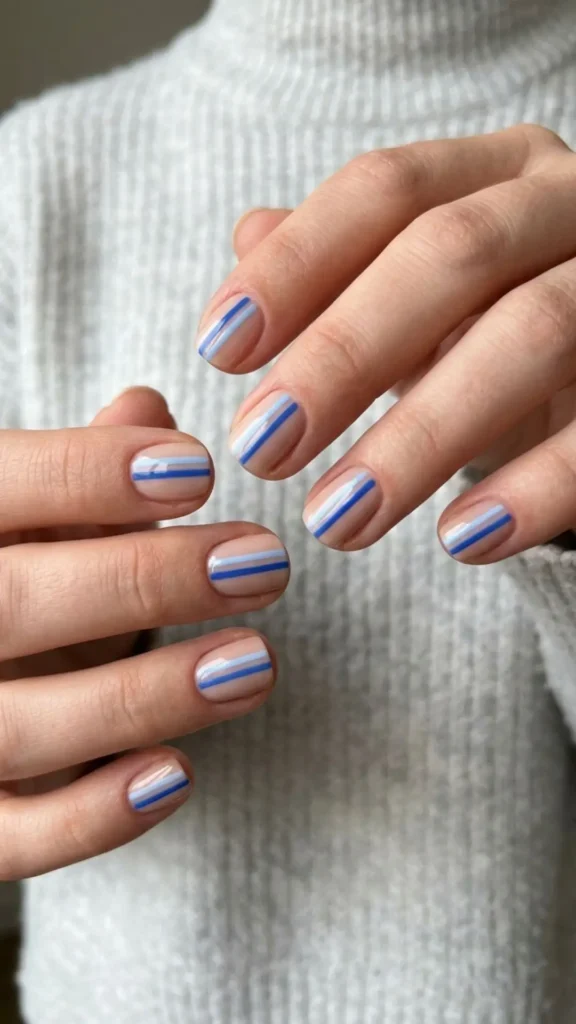 Double blue stripe nails with clean French-style detailing for a fresh and modern transitional manicure.