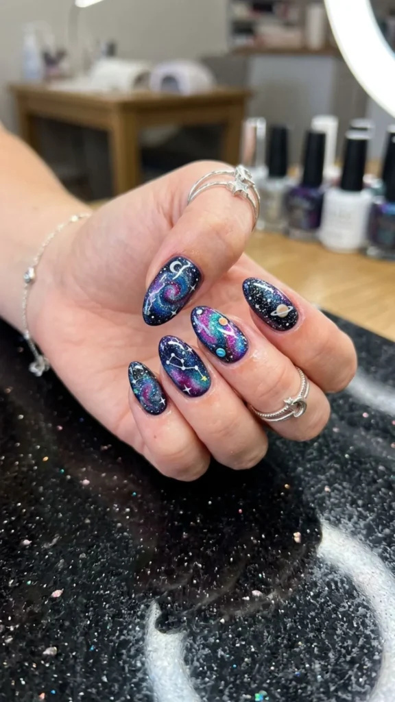 Stunning galaxy nail art with cosmic colors, sparkling stars, and dreamy space-inspired details.