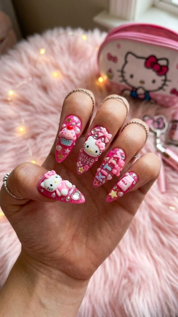  Hello Kitty pink nails featuring cute bows, sparkling gems, and playful 3D junk nail decorations.