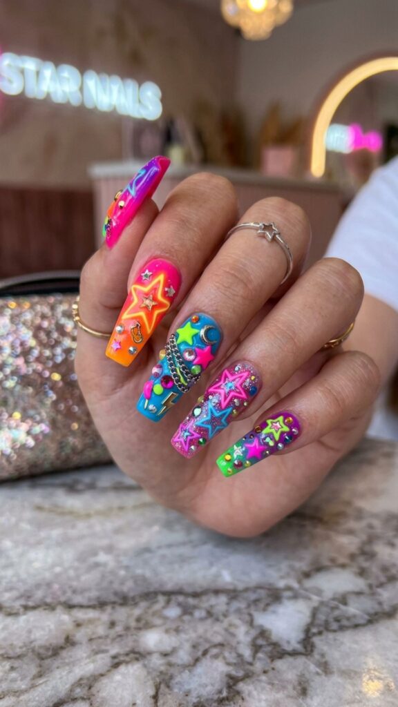 Neon star nails with vibrant fluorescent colors, sparkling stars, bold charms, and eye-catching 3D junk nail art.