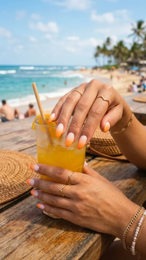 Orange and white gradient nails blending bright summer shades with a smooth ombre effect.