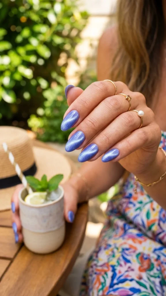 Shimmering periwinkle cat eye nails with a magnetic glossy finish.