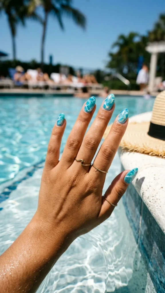 Shimmering pool water nails inspired by sparkling blue summer waves.
