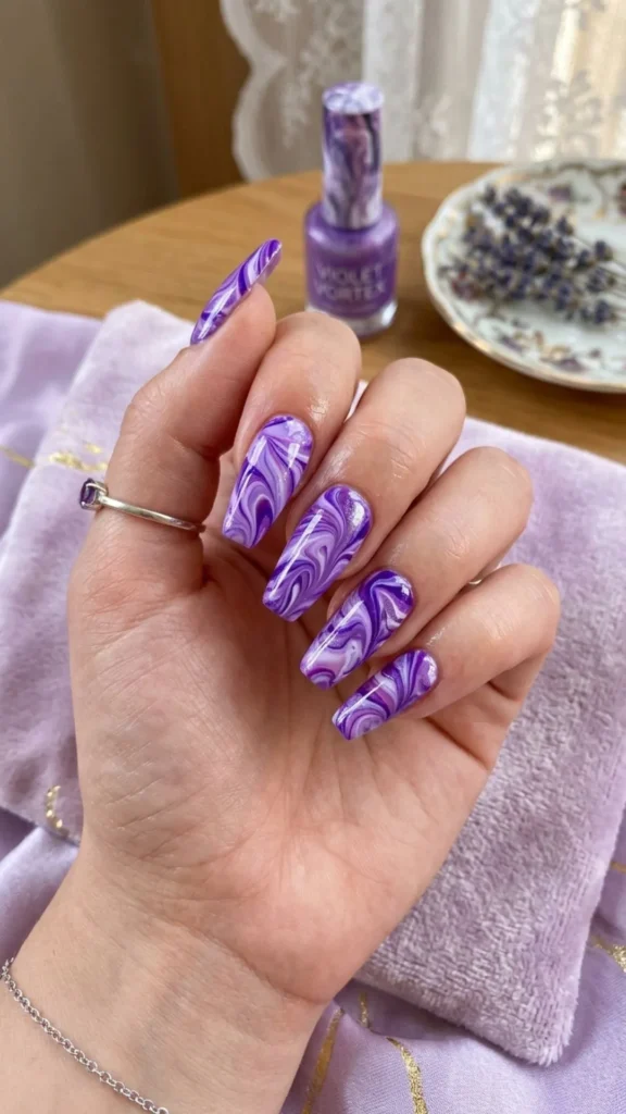 Purple marble nails with elegant swirling patterns